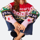 Person wearing a colorful Christmas-themed sweater with 'HO HO HO' and 'Merry Xmas' text.